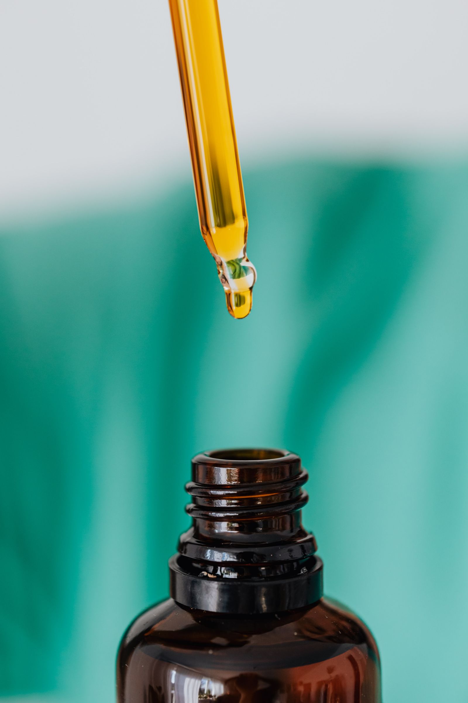 A calm, clinical amber glass bottle with a dropper on a neutral background.
